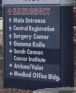 A grainy Google Street View picture of a bad hospital sign